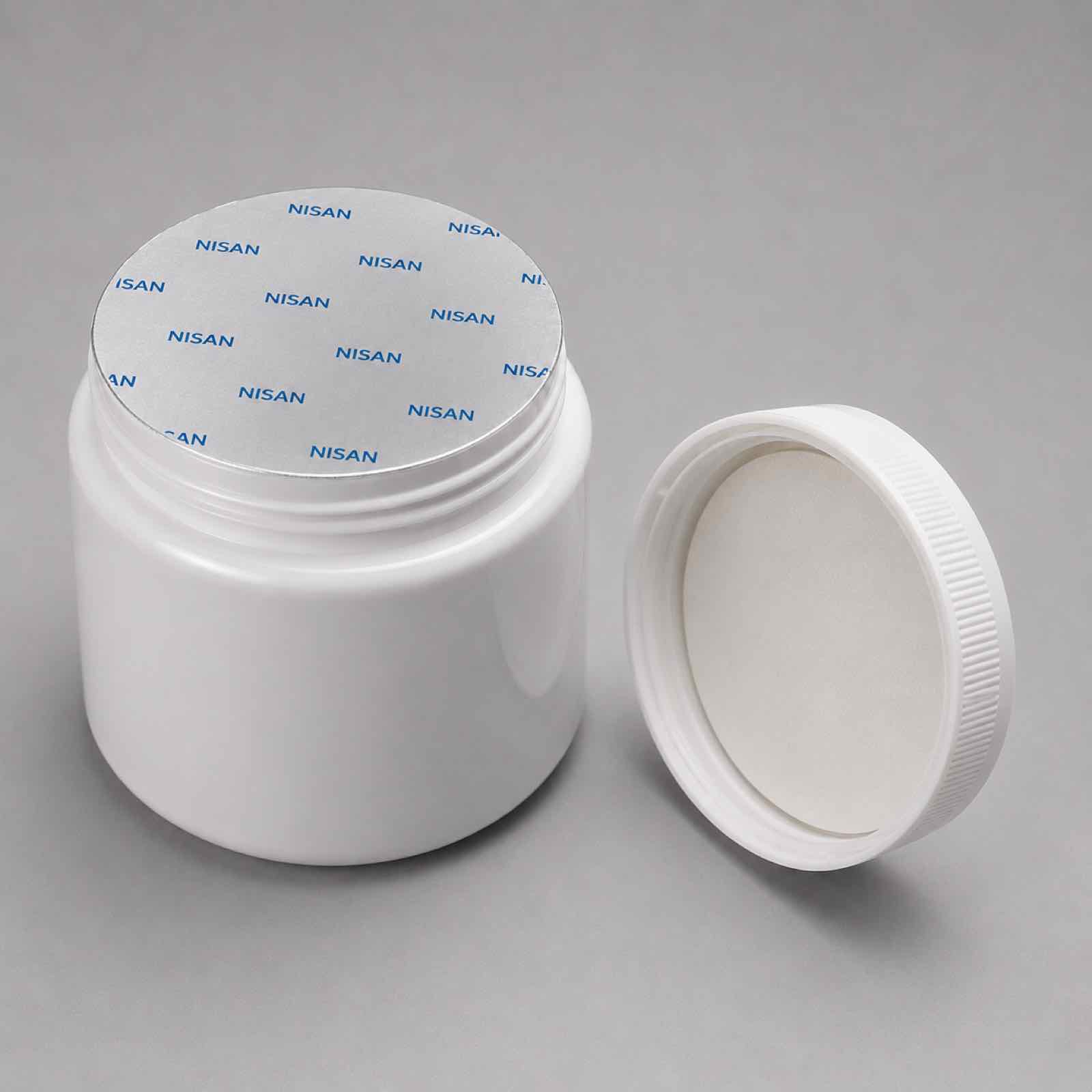 NISAN bottle sealed with an induction liner beside its cap